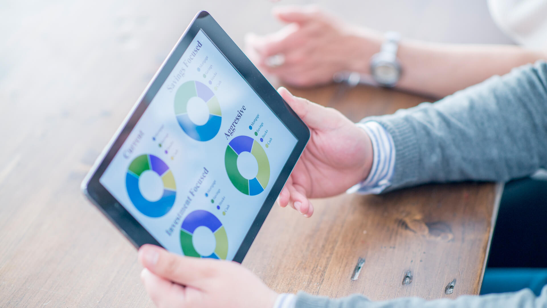 A businessman is looking at a chart of the companies portfolio on a digital tablet.